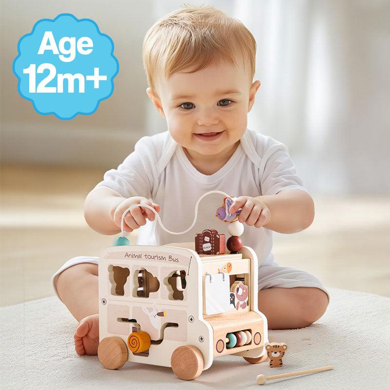 Baby playing with 8-in-1 Wooden Montessori Busy Bus toy designed for ages 12 months and up